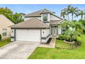 This beautiful home boasts mature landscaping, a two-car garage, and an inviting front entrance at 3408 Idlegrove Ct, Orlando, FL 32822