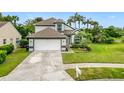 Charming two-story home with a well-manicured lawn, a two-car garage, and mature trees at 3408 Idlegrove Ct, Orlando, FL 32822