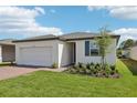 Lovely single-story home boasting a brick driveway, two-car garage, and manicured garden at 3872 Giorgio Dr, Winter Haven, FL 33884