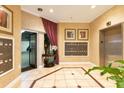 Welcoming lobby with tile flooring, elevator, and mailboxes for residents at 401 E Robinson St # 202, Orlando, FL 32801