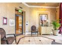 Inviting lobby area with neutral colors, tiled floor, furniture, and front door access at 401 E Robinson St # 202, Orlando, FL 32801