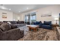 Spacious living room with neutral walls, large windows, plush seating, and access to the pool at 4353 Lana Ave, Davenport, FL 33897