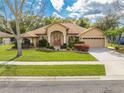 Lovely single-story home featuring mature landscaping, well-maintained lawn, and an attached two-car garage at 4933 Raylene Way, St Cloud, FL 34771