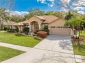 Beautifully maintained single-story home with manicured lawn, mature landscaping, and attached two-car garage at 4933 Raylene Way, St Cloud, FL 34771