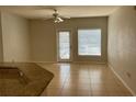 Living room featuring tile flooring, neutral paint, and a sliding glass door to the outside at 5959 Westgate Dr # 1526, Orlando, FL 32835