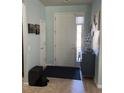 Light and airy foyer featuring a white door, neutral walls, and decorative accents at 6832 Sw 93Rd Ave, Ocala, FL 34481
