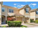 Well-maintained townhouse with brick paved driveway, attached garage and manicured landscaping at 6936 Hochad Dr, Orlando, FL 32819