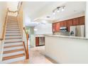 Open kitchen featuring granite countertops, stainless steel appliances, and easy access to the staircase at 6936 Hochad Dr, Orlando, FL 32819