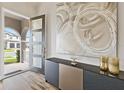 Elegant foyer showcasing modern decor, stylish console, and natural light from the front door at 9947 Summerlake Groves St, Winter Garden, FL 34787