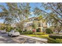 Condo building featuring well-manicured landscaping and ample parking for residents and guests at 11564 Mizzon Dr # 305, Windermere, FL 34786