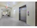 Hallway with elevator and carpet at 11564 Mizzon Dr # 305, Windermere, FL 34786