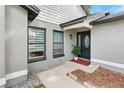 Inviting front entrance with a black front door, well-maintained landscaping, and stylish accents at 1296 Bridlebrook Dr, Casselberry, FL 32707