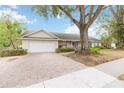 Front exterior showing the attached garage, mature landscaping, and covered entrance at 1432 Northridge Dr, Longwood, FL 32750