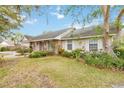 Exterior view of a brick and siding home with well-maintained landscaping and a lush lawn at 1432 Northridge Dr, Longwood, FL 32750