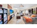 Comfortable living room featuring a spacious gray couch, ceiling fan and natural light at 1493 Hyde Park Dr, Winter Park, FL 32792