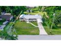 Well-kept home featuring metal roof, covered parking, fenced yard, and exterior storage sheds at 15 Palmira Rd, Debary, FL 32713