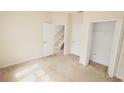 Bright bedroom with neutral carpeting, closet, and interior doors at 17519 Blessing Dr, Clermont, FL 34714