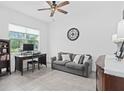 Comfortable spare bedroom featuring tile floors, a ceiling fan, and ample natural light at 2091 Brillante Dr, St Cloud, FL 34771