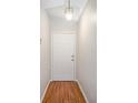 Bright foyer featuring wood-look flooring and a white front door at 2209 Hannah Ln, Orlando, FL 32826