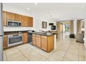 Well-lit kitchen and dining area with stainless steel appliances and access to the outdoor patio at 2647 Corvette Ln, Kissimmee, FL 34746