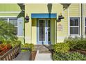 Close-up of a Caribbean Dream home's entrance, showcasing the vibrant colors and lush landscaping at 2925 Caribbean Soul Dr, Kissimmee, FL 34747