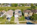 Aerial view of a residential property showcasing the home, surrounding lawns, landscaping, and neighborhood at 5239 Los Palma Vista Dr, Orlando, FL 32837