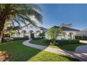 Stunning exterior features arched entryways, a terracotta roof, and beautiful landscaping at 535 Spring Club Dr, Altamonte Springs, FL 32714