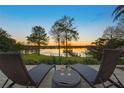 Relaxing patio with chairs, a small table and stunning lake views at 535 Spring Club Dr, Altamonte Springs, FL 32714