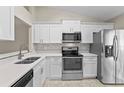 Modern kitchen featuring stainless steel appliances and white cabinets at 56 Pine Island Cir, Kissimmee, FL 34743