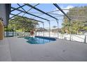 Backyard pool with screened enclosure, offering a private outdoor relaxation space at 729 Strihal Loop, Oakland, FL 34787