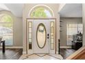 Bright foyer with an arched transom window and a decorative front door with custom glass at 8534 Black Mesa Dr, Orlando, FL 32829