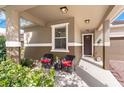 Welcoming front porch with seating, a view of the neighborhood and manicured landscaping at 8813 Tatara, Orlando, FL 32836