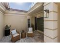 Cozy front porch featuring wicker chairs, perfect for relaxing and enjoying the outdoors at 8929 Charleston Park # 12, Orlando, FL 32819