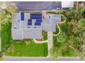 Birds eye view of home with backyard, landscaping and solar panels on roof at 936 N Baker St, Mount Dora, FL 32757