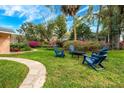 Spacious backyard area featuring comfortable chairs and lush landscaping at 936 N Baker St, Mount Dora, FL 32757