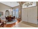 Inviting foyer with tile and wood floors leads to an elegant dining area with large windows and natural light at 1154 Seneca Trl, St Cloud, FL 34772