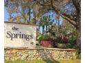 Entrance sign for The Springs community surrounded by mature landscaping at 116 Crown Oaks Way # 116, Longwood, FL 32779