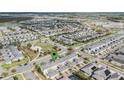 An aerial view of a residential community featuring tree lined streets, several ponds and green spaces at 12024 Sonnet Ave, Orlando, FL 32832