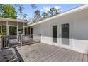 Wooden deck with access to the screened porch and backyard; great for entertaining at 13128 Devonshire Rd, Orlando, FL 32832