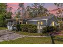 Charming single-story home with screened porch, patio, and lush landscaping at 13128 Devonshire Rd, Orlando, FL 32832