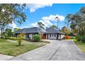 Spacious home with a long driveway, a two-car garage, and a beautifully landscaped front yard at 137 Spring Chase Cir, Altamonte Springs, FL 32714