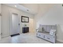 Bright entryway featuring tile floors and decorative bench with accent pillows at 1722 Lake Sims Pkwy, Ocoee, FL 34761