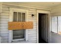 Exterior shot of an entrance to a home with boarded up windows at 1803 S Westmoreland Dr, Orlando, FL 32805