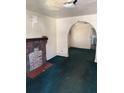 Living room featuring an archway, brick fireplace and green carpet at 1803 S Westmoreland Dr, Orlando, FL 32805