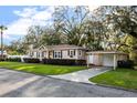 Traditional home with a well-manicured lawn and a convenient garage and carport at 1818 S Oak Ave, Sanford, FL 32771