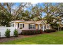 Charming home with manicured lawn, a white picket fence and lush greenery at 1818 S Oak Ave, Sanford, FL 32771