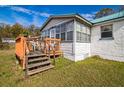 Quaint home features a welcoming deck and freshly painted siding at 24813 E Highway 316, Salt Springs, FL 32134