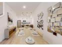 Open-concept dining area with modern decor, pendant lights, and seamless connection to the kitchen at 257 Famagusta Dr, Davenport, FL 33896