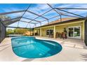 Relaxing screened-in pool area with a sparkling pool, patio furniture, and ample lounging space at 2726 Babbitt Ave, Orlando, FL 32833