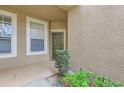 Inviting entryway featuring a decorative door and manicured landscaping at 2847 Metro Sevilla Dr # 103, Orlando, FL 32835